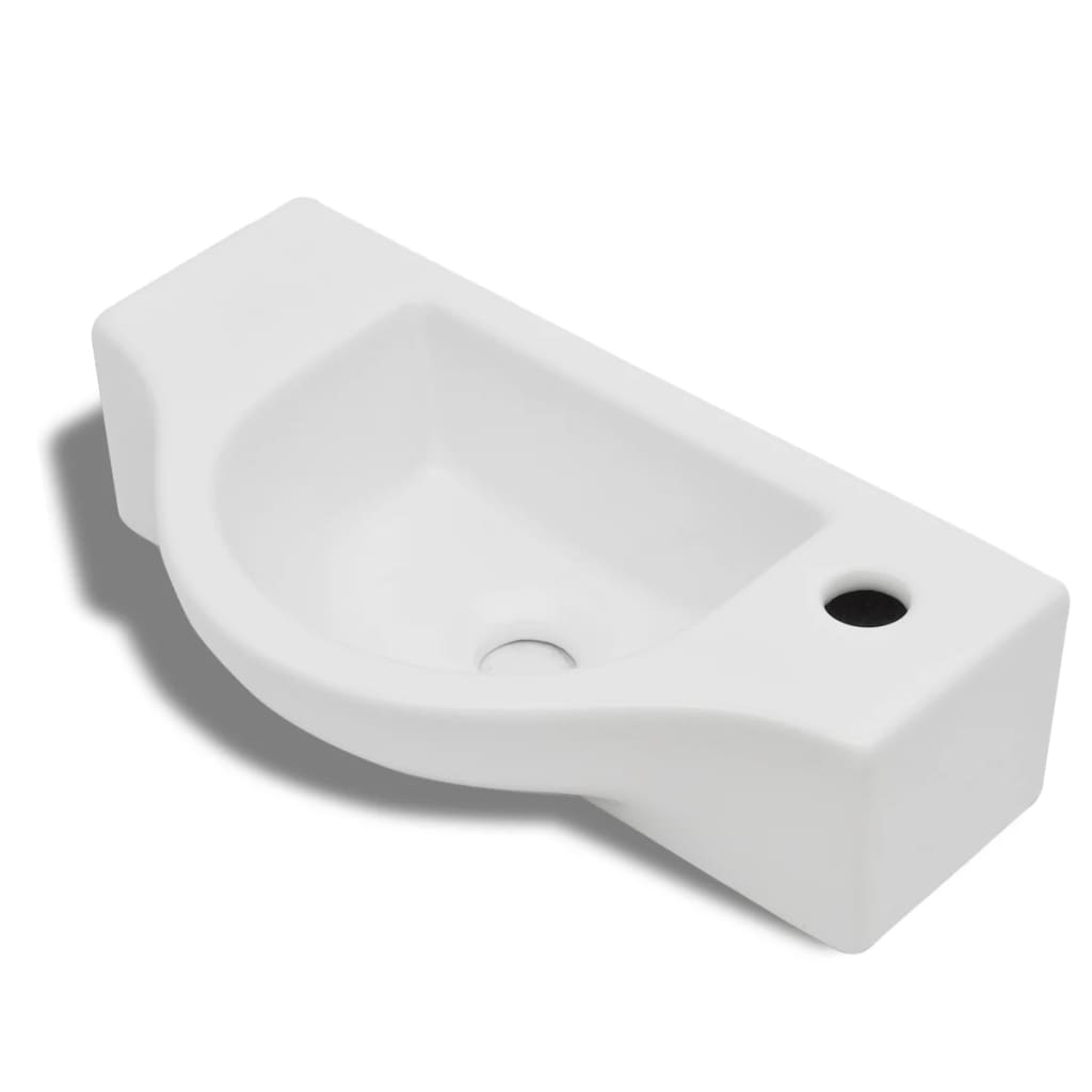 White ceramic bathroom sink with drain hole