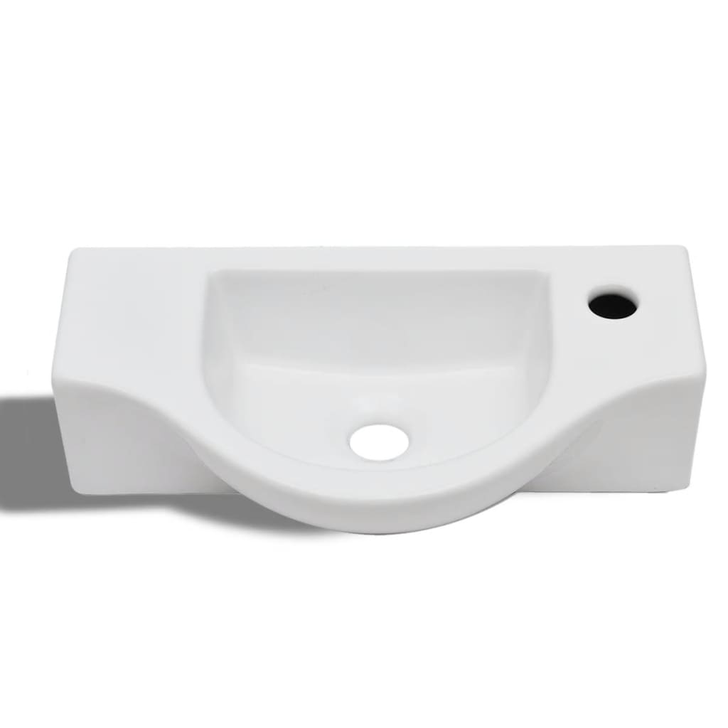 White ceramic bathroom sink with drain hole