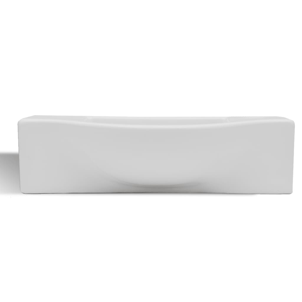 White ceramic bathroom sink with drain hole