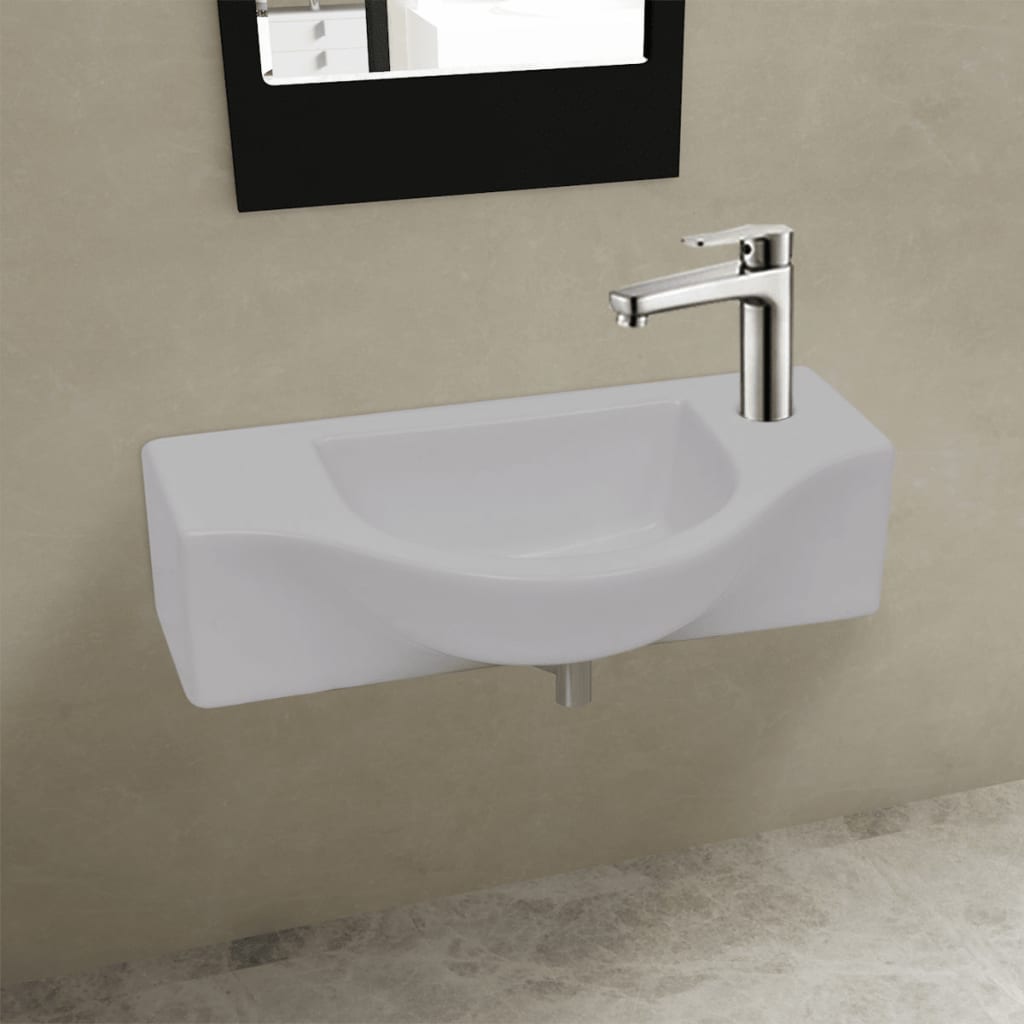 White ceramic bathroom sink with drain hole