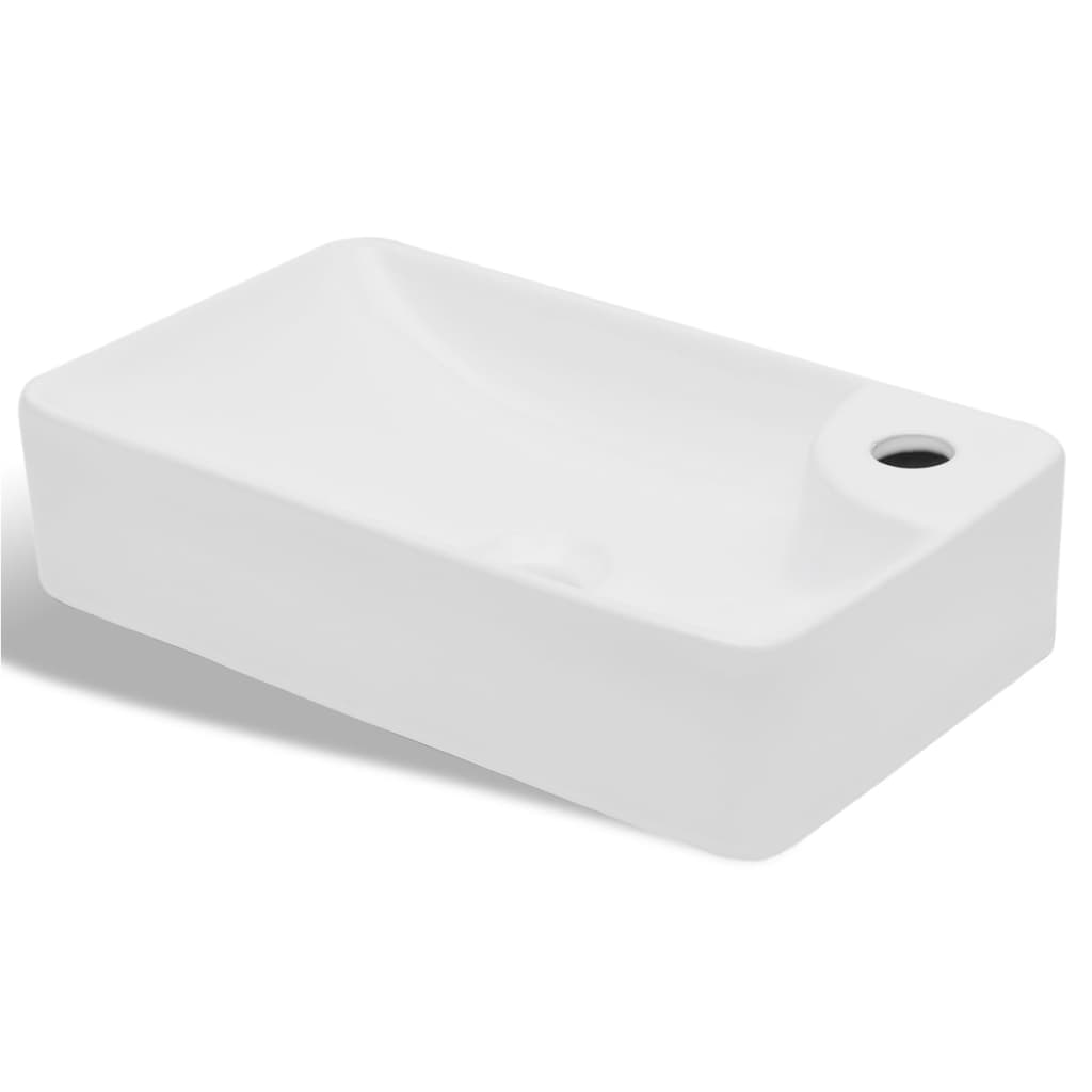 White ceramic bathroom sink with drain hole