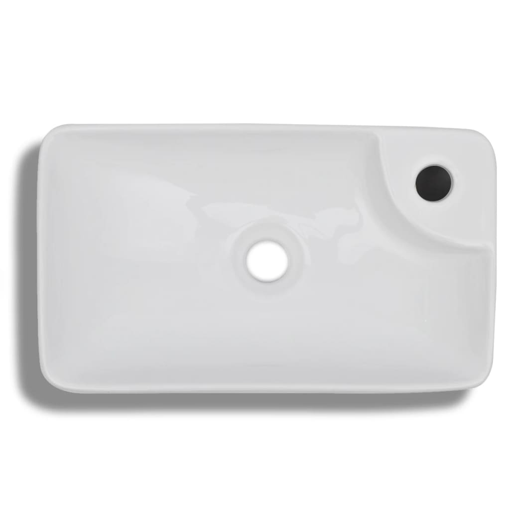 White ceramic bathroom sink with drain hole