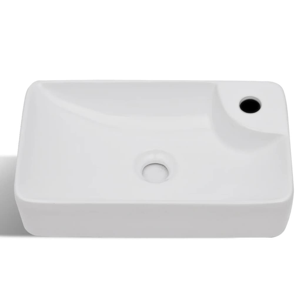 White ceramic bathroom sink with drain hole